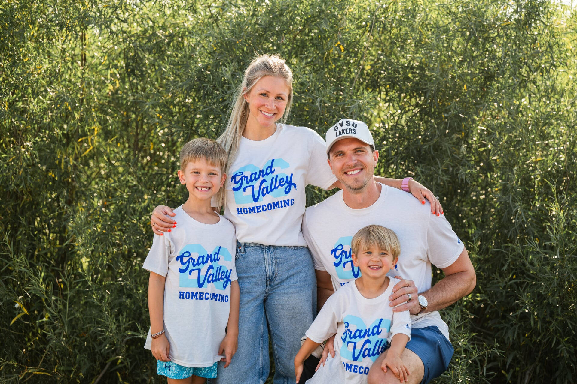 Family smiles wearing GVSU Homecoming t-shirts